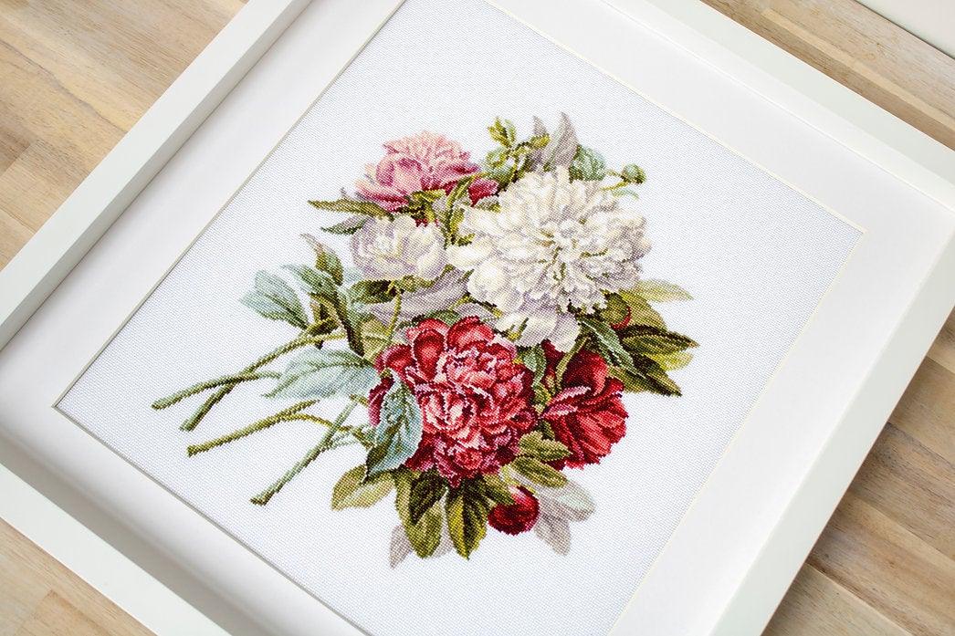 Piones B2355L Counted Cross-Stitch Kit featuring colorful threads, canvas, and needle for crafting.